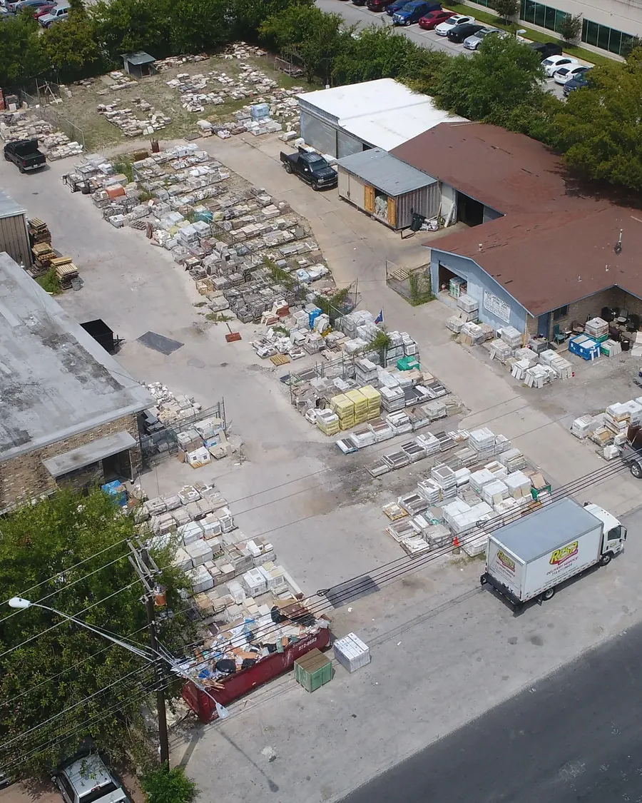 The Tedford yard from above: pallets of tile stacked in rows beside the showroom